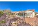 Charming single-story home with a covered patio, landscaped yard and desert-friendly landscaping at 9809 Gerald Ct, Las Vegas, NV 89134