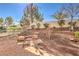 Well-maintained backyard with decorative rock, stone benches and mature landscaping at 9809 Gerald Ct, Las Vegas, NV 89134