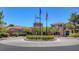 Attractive clubhouse entrance with manicured landscaping and American flags on display at 9809 Gerald Ct, Las Vegas, NV 89134