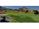 Scenic golf course with a black golf cart and mountain views in the background at 9809 Gerald Ct, Las Vegas, NV 89134