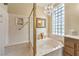 Bright main bathroom showcases a luxurious bathtub, a glass shower, and marble accents at 9809 Gerald Ct, Las Vegas, NV 89134