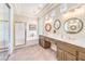 This main bathroom boasts a large tub, a glass shower, double sinks and lots of natural light at 9809 Gerald Ct, Las Vegas, NV 89134