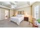 Well-lit main bedroom with a large bed, decorative furniture and view into the bathroom at 9809 Gerald Ct, Las Vegas, NV 89134