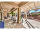 Covered patio featuring stone pillars, an outdoor seating area, and a well-manicured yard at 9809 Gerald Ct, Las Vegas, NV 89134