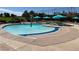 Community pool with a fountain and several umbrella covered tables for residents' enjoyment at 9809 Gerald Ct, Las Vegas, NV 89134