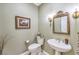 Charming powder room with decorative mirror and elegant fixtures to impress any guest at 9809 Gerald Ct, Las Vegas, NV 89134