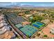 Beautiful aerial view of the neighborhood including pool, tennis courts, and clubhouse at 9912 Woodhouse Dr, Las Vegas, NV 89134