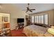 Bedroom featuring large window with plantation shutters, vaulted ceiling and ceiling fan at 9912 Woodhouse Dr, Las Vegas, NV 89134