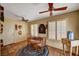 Cozy dining area features Saltillo tile flooring, windows with plantation shutters, and modern ceiling fans at 9912 Woodhouse Dr, Las Vegas, NV 89134