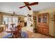 Charming dining area open to the kitchen, featuring Saltillo flooring and a vintage china cabinet at 9912 Woodhouse Dr, Las Vegas, NV 89134