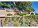 Entrance to Sun City Summerlin community. Beautiful landscaping complements the community's entrance sign at 9912 Woodhouse Dr, Las Vegas, NV 89134