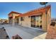 Exterior elevation view of the house featuring desert landscaping with a large concrete backyard patio at 9912 Woodhouse Dr, Las Vegas, NV 89134