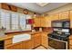 Farmhouse sink and stainless steel oven in bright kitchen with wood cabinets at 9912 Woodhouse Dr, Las Vegas, NV 89134