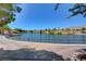 Scenic view of the pond in the community featuring lush landscaping and mountain views at 9912 Woodhouse Dr, Las Vegas, NV 89134