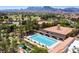 Aerial shot of the community pool and clubhouse with mountain views and manicured landscaping at 9912 Woodhouse Dr, Las Vegas, NV 89134