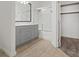 Modern bathroom featuring a double vanity, gray cabinets, shower, and a bathtub at 10225 King Henry Ave # 102, Las Vegas, NV 89144