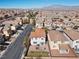 Community aerial view, showcasing houses with tile roofs and manicured landscaping under a sunny sky at 10655 Tray Mountain Ave, Las Vegas, NV 89166