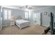 Spacious bedroom with carpet, ceiling fan, shutters, and ensuite bathroom access at 1125 Via Canale Dr, Henderson, NV 89011