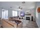 Inviting living room with a decorative fireplace, ceiling fan, and ample seating with natural light at 1125 Via Canale Dr, Henderson, NV 89011