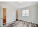 Bedroom with wood floors, light walls, window with blinds and access to hallway at 1153 Dusty Creek St, Las Vegas, NV 89128