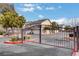 Entry gate to the residences with desert landscaping, trees, and community buildings at 1153 Dusty Creek St, Las Vegas, NV 89128