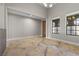 Open living room boasting a wooden door, marble-look flooring, and two large windows at 12135 Kite Hill Ln, Las Vegas, NV 89138