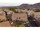 Aerial view of a neighborhood with similar townhomes, street, and cars parked with desert mountains in the background at 1292 Large Cap Dr # 3, Henderson, NV 89074