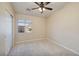 Well-lit bedroom with neutral carpet and a window, enhanced by a ceiling fan at 1292 Large Cap Dr # 3, Henderson, NV 89074