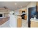 This modern kitchen features stainless steel appliances and an island with white countertop at 1292 Large Cap Dr # 3, Henderson, NV 89074