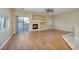 Bright living room with a fireplace, wood-look floors, ceiling fan, and sliding glass door to patio at 1292 Large Cap Dr # 3, Henderson, NV 89074