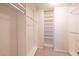 Organized walk-in closet with shelving and hanging rods for efficient storage solutions at 1292 Large Cap Dr # 3, Henderson, NV 89074