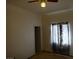 Bedroom with neutral walls, ceiling fan, and a window partially covered by a patterned curtain at 1437 Blankenship Ave, Las Vegas, NV 89106