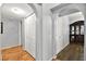 Hallway with laminate wood flooring, closet, archway, and dark wood cabinet at 1451 Di Blasi Dr # 102, Las Vegas, NV 89119