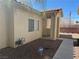 Tan home exterior featuring a terracotta roof, walkway, desert landscaping, and home security system at 1881 W Alexander Rd # 1035, North Las Vegas, NV 89032
