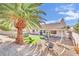 Beautiful backyard featuring a above ground pool, palm tree, and a stone fire pit at 1914 Night Shadow Ave, North Las Vegas, NV 89031