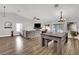 Spacious living room with hardwood floors, a ceiling fan, and a sliding glass door at 1914 Night Shadow Ave, North Las Vegas, NV 89031