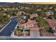 Panoramic aerial shot of a two-story home with a red tile roof, desert landscaping, and solar panels at 1921 Spyglass Dr, Henderson, NV 89074