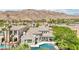 A scenic aerial view showcasing a luxurious home with a pool, set against a mountain backdrop at 2690 Grassy Spring Pl, Las Vegas, NV 89135