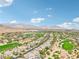 Breathtaking aerial view of a golf course community set against a stunning mountain backdrop at 2690 Grassy Spring Pl, Las Vegas, NV 89135