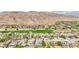 Picturesque aerial view of luxury homes next to a golf course with mountain views at 2690 Grassy Spring Pl, Las Vegas, NV 89135
