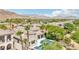 An aerial view of a neighborhood with a pool in the backyard and a mountain view at 2690 Grassy Spring Pl, Las Vegas, NV 89135