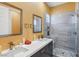 Modern bathroom with dual sinks, glass-enclosed shower, and gray tile at 2690 Grassy Spring Pl, Las Vegas, NV 89135