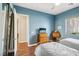 Bedroom with hardwood floors, twin beds, and blue accent wall at 2690 Grassy Spring Pl, Las Vegas, NV 89135