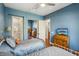 Comfortable blue bedroom features two beds, a ceiling fan, and an ensuite bathroom with shower at 2690 Grassy Spring Pl, Las Vegas, NV 89135