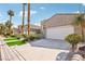 Lovely home with desert landscaping, a two-car garage, and a well-manicured lawn at 2690 Grassy Spring Pl, Las Vegas, NV 89135