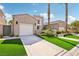 Inviting home with manicured landscaping, a two-car garage, and a well-maintained front yard at 2690 Grassy Spring Pl, Las Vegas, NV 89135