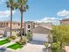 Beautiful two-story home with lush landscaping, a two-car garage, and a well-maintained yard at 2690 Grassy Spring Pl, Las Vegas, NV 89135