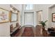 Elegant foyer with hardwood floors, high ceilings, decorative mirror and beautiful rug at 2690 Grassy Spring Pl, Las Vegas, NV 89135
