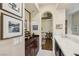 Hallway features a wine bar and leads to a sitting area with an abundance of natural light at 2690 Grassy Spring Pl, Las Vegas, NV 89135