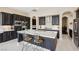 Spacious kitchen with a large island, dark cabinets, and stainless steel appliances at 2690 Grassy Spring Pl, Las Vegas, NV 89135